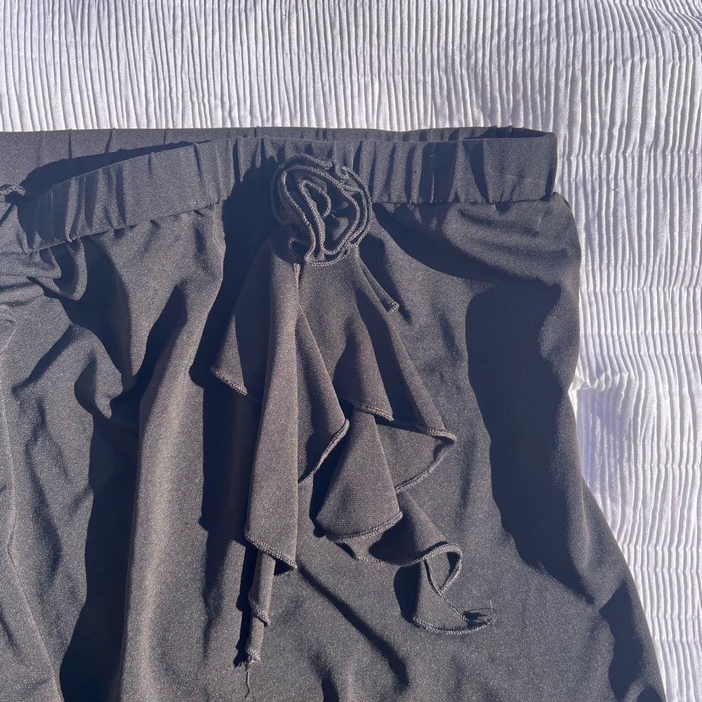 Brand “MALDITA” small mid length black skirt with flower detail